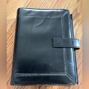 Black Leather (?) Day Timer Planner with Extra pages.